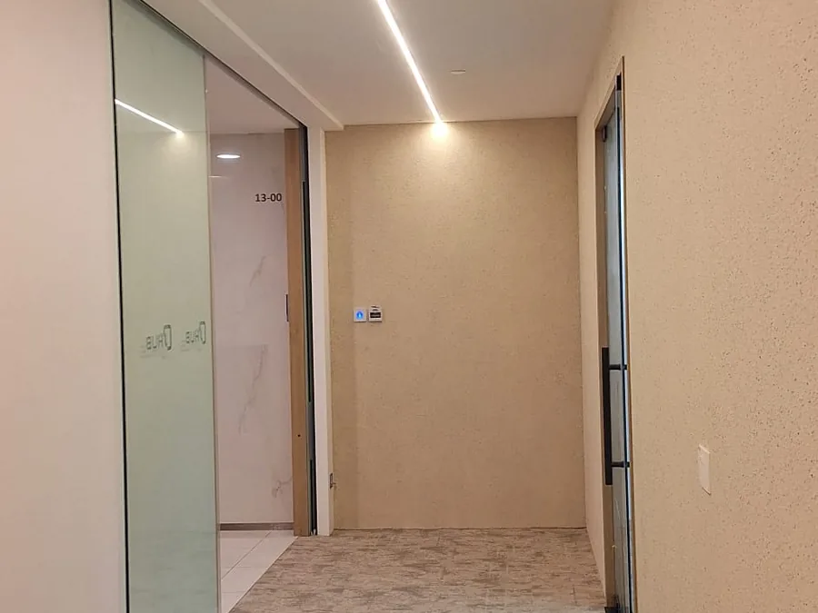 Completed private office suite entrance with frosted glass doors